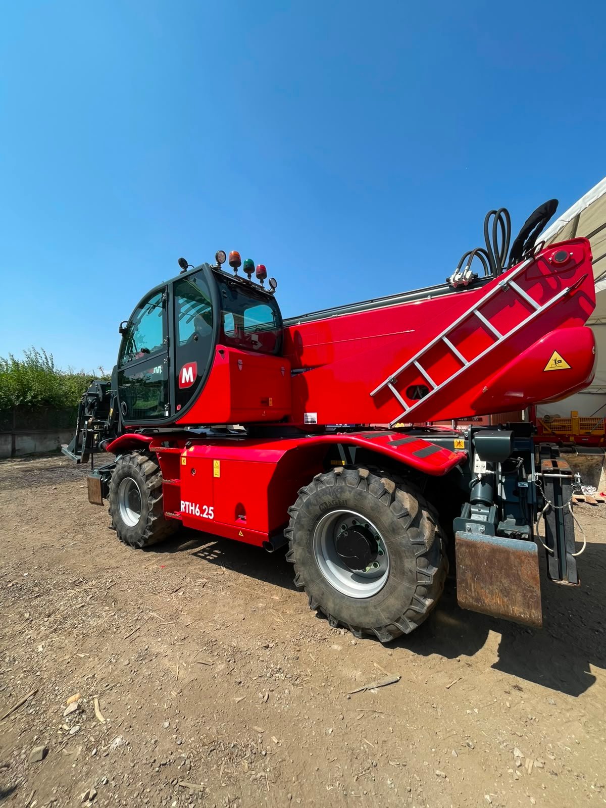Red rotating telehandler on construction site