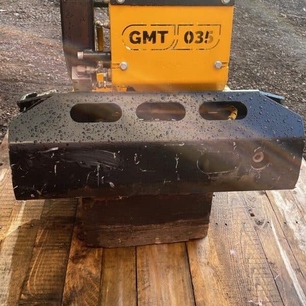 Yellow GMT 035 hydraulic compactor attachment on wooden platform