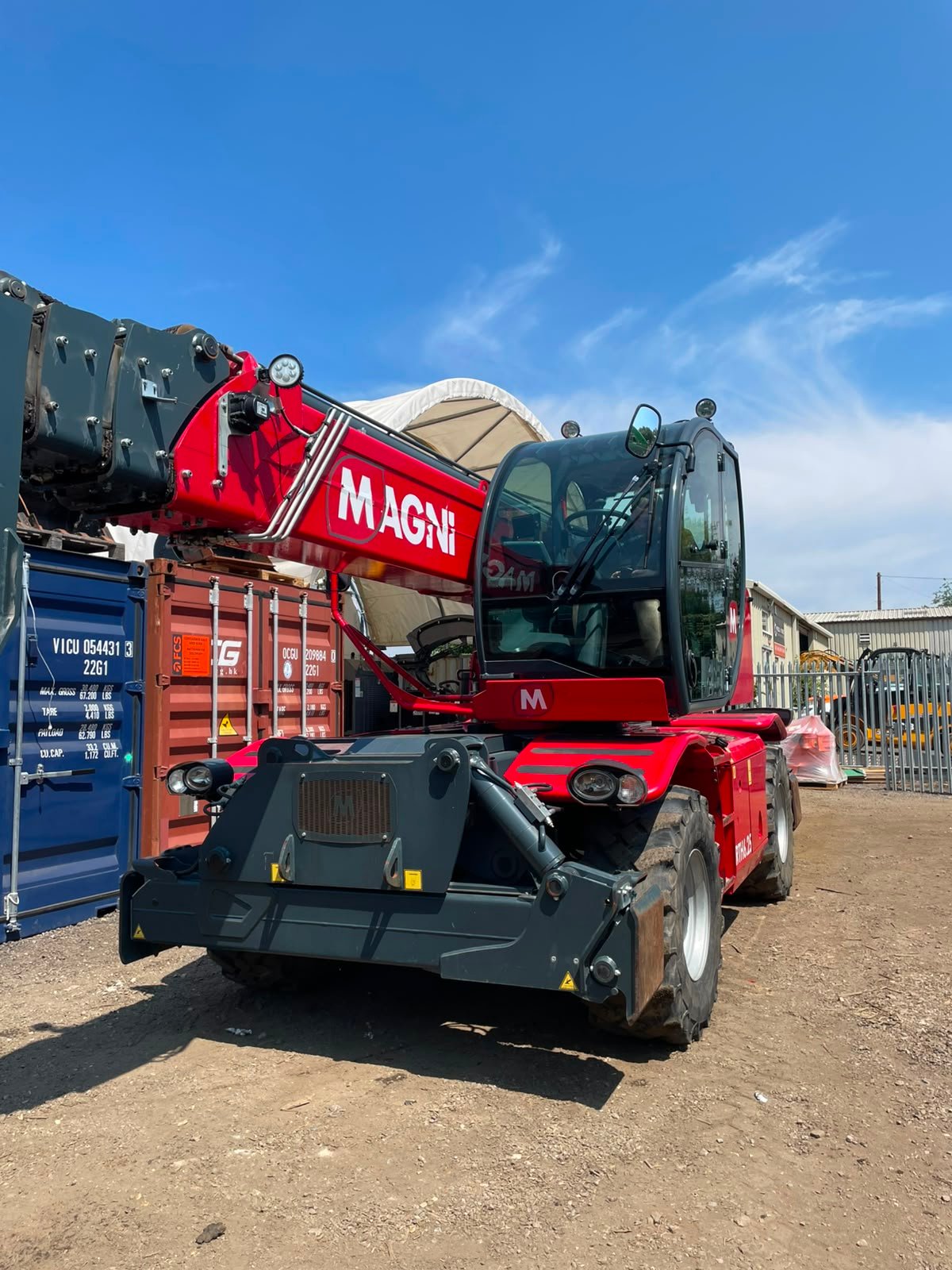 Red Magni telehandler parked in industrial yard