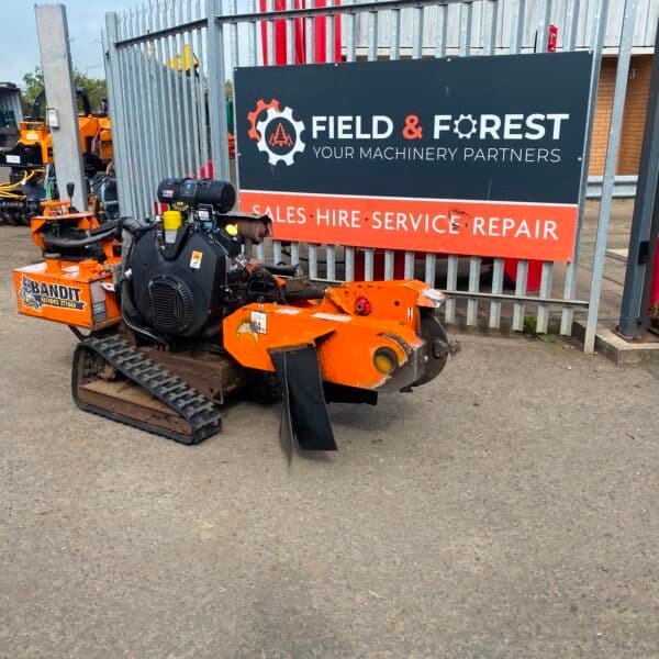 Orange Bandit stump grinder outside machinery yard