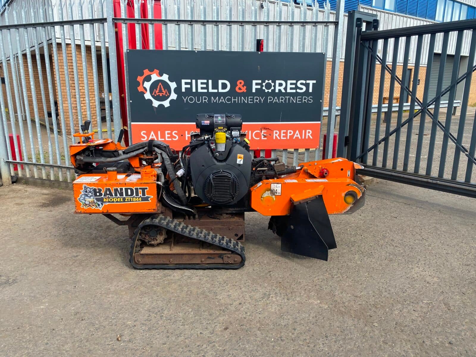 Orange Bandit stump grinder on tracks outdoors