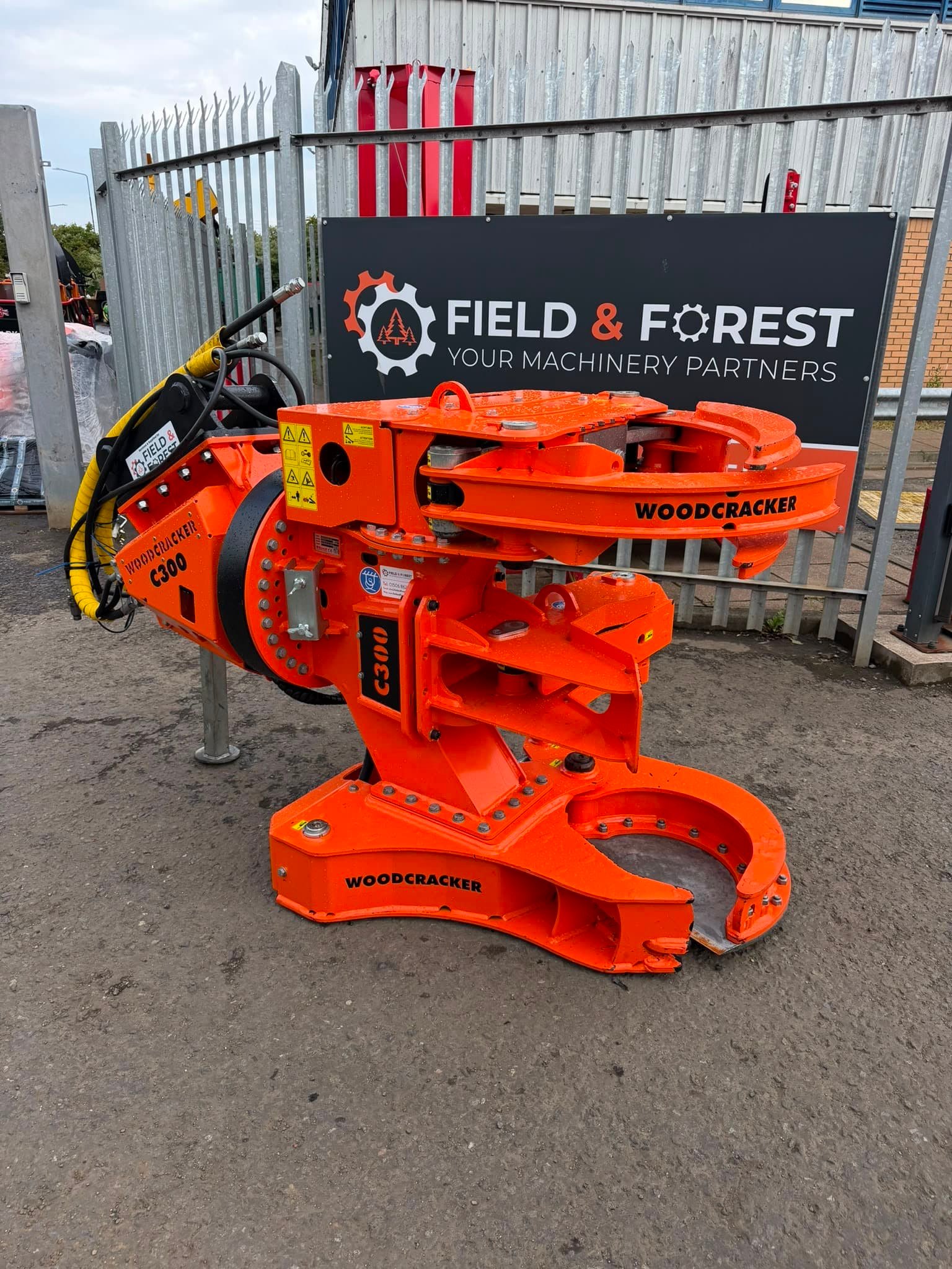 Woodcracker C300 forestry attachment in industrial yard