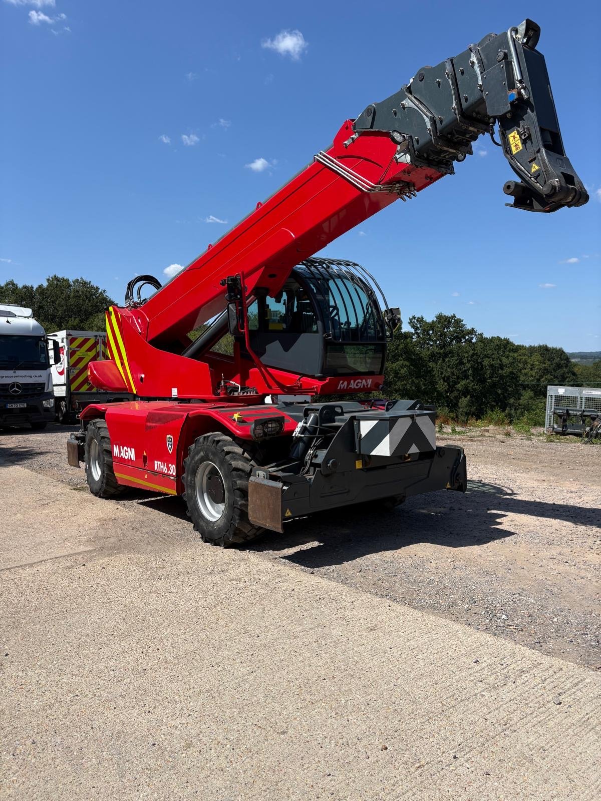 Red Magni rotating telehandler on construction yard