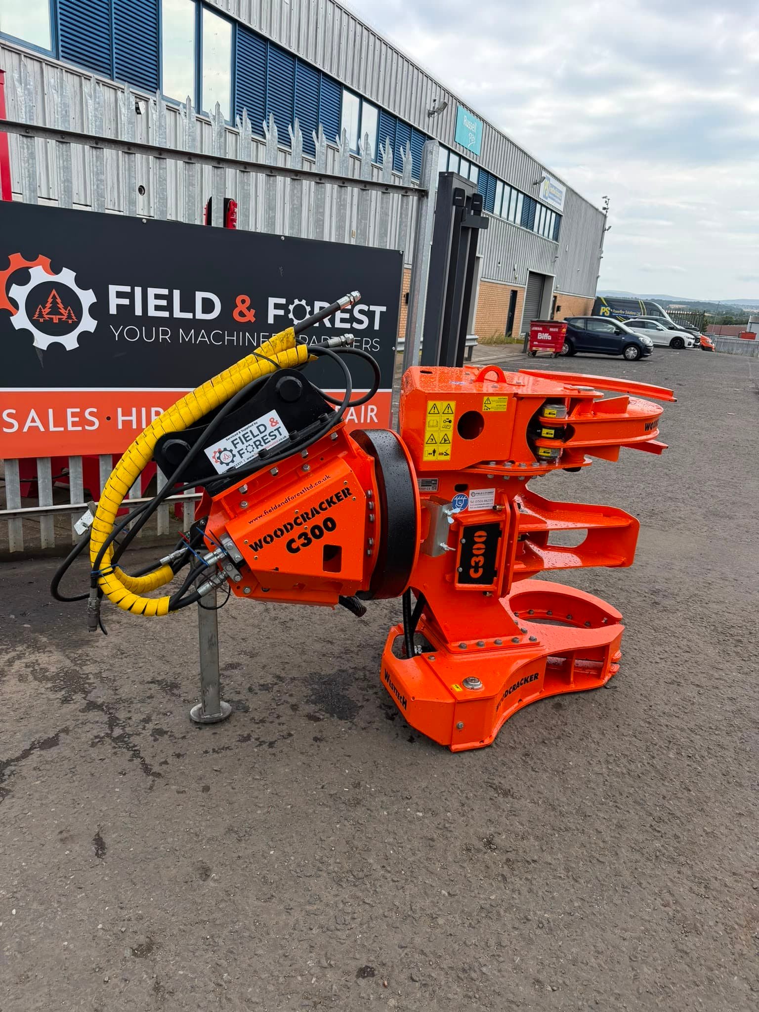 Orange Woodcracker C300 tree shear attachment outdoors