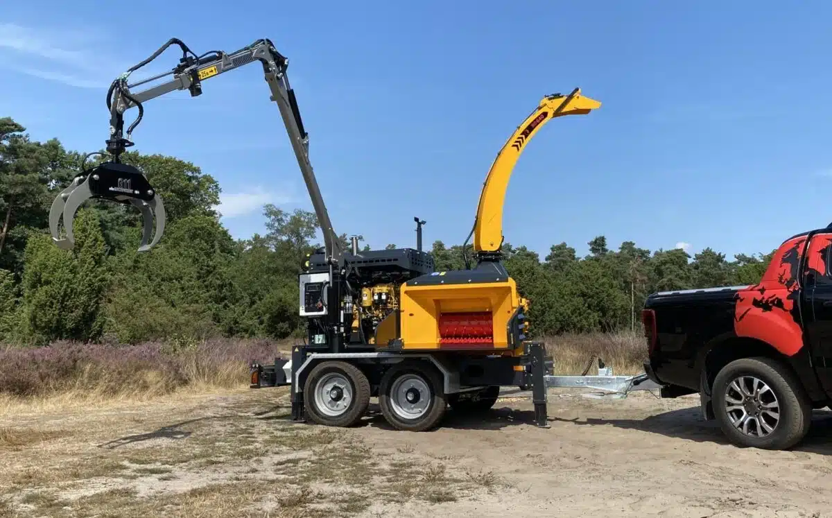 Europe Chippers EC640 towable wood chipper with crane in woodland clearing