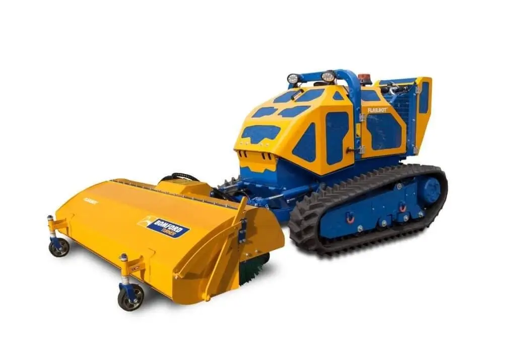 Yellow and blue tracked industrial sweeper machine