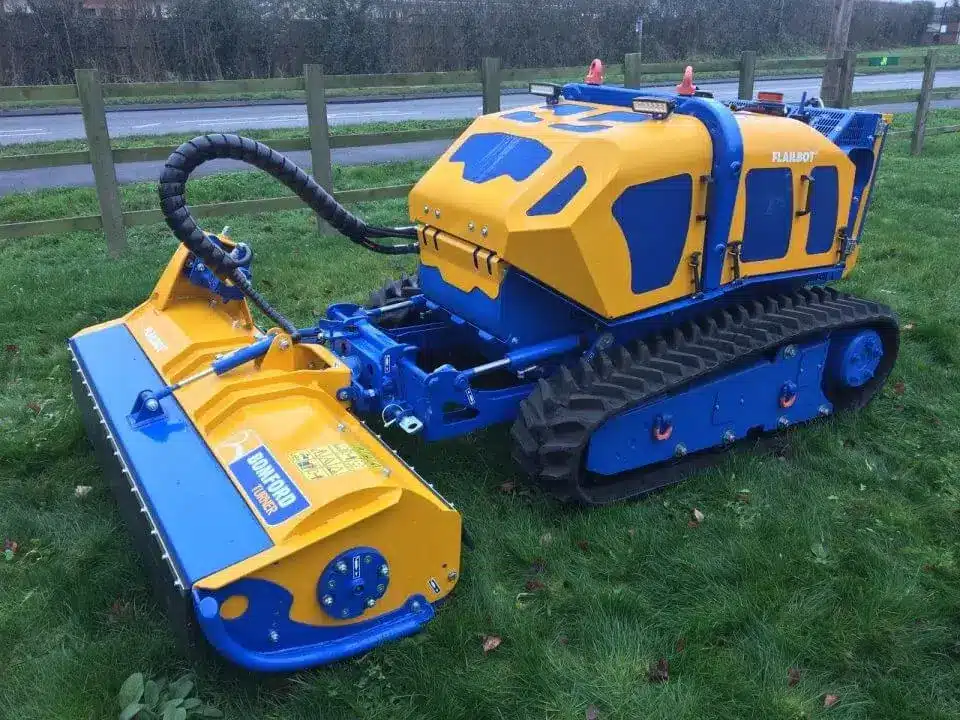 Bomford Flailbot Original remote‑controlled mower working on steep grass embankment.